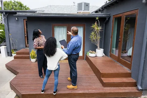 Couple viewing a house and its surrounding neighborhood in person