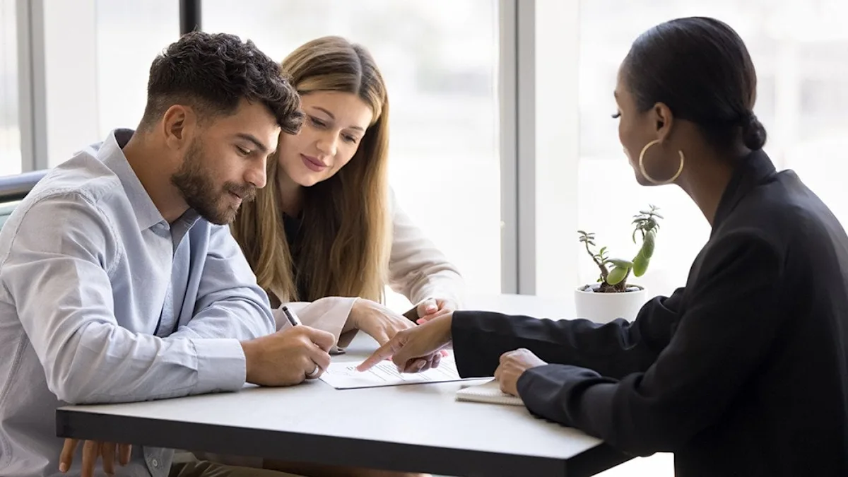 Buyer signing a sale and purchase agreement for a property purchase