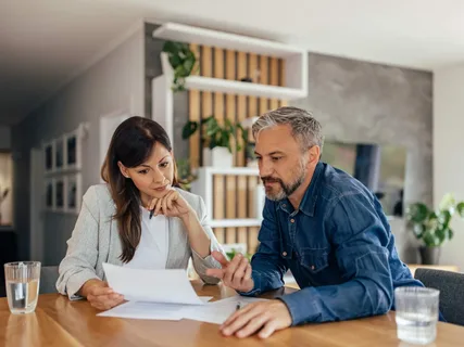 Real estate agent explaining local property market trends to homeowner