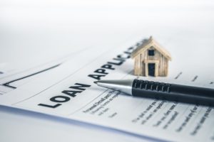 Person signing a home mortgage loan application form