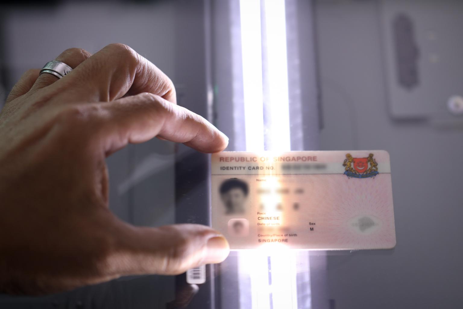 NRIC and identification documents laid out for identity verification during a property transaction