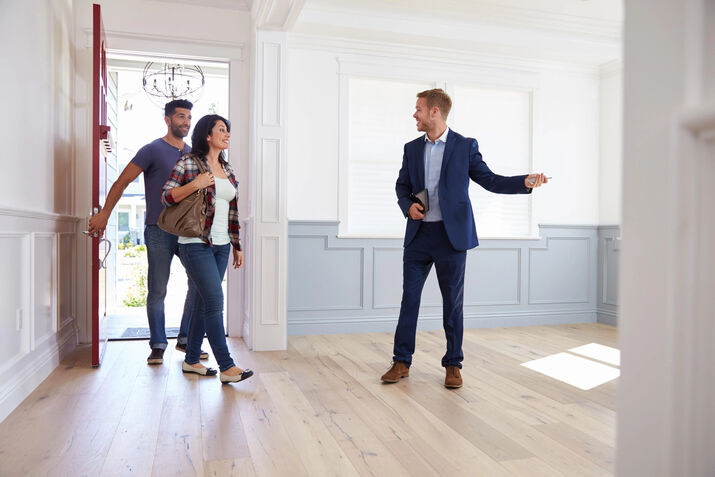 Real estate agent showing a couple around a Kuala Lumpur condominium