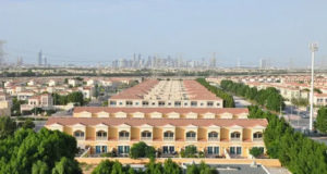 Jumeirah Village Circle mid-rise apartment buildings and community park 