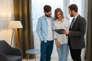 Real estate agent discussing property documents with a client in a Dubai office