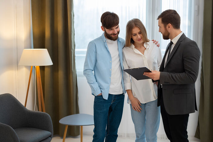 Real estate agent discussing property documents with a client in a Dubai office