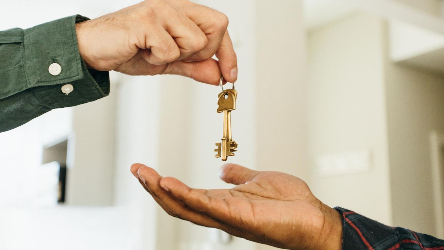 Couple receiving keys at an HDB resale completion appointment Couple receiving keys at an HDB resale completion appointment